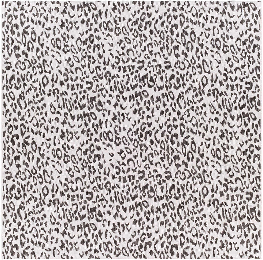 Close-up of Alderbury White Leopard Print Rug. Black animal spots pattern on off-white polypropylene rug. Design-Square-7