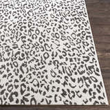Close-up of Alderbury White Leopard Print Rug showing black animal spots on off-white woven polypropylene. Front