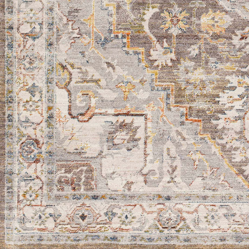 Close-up of the LeChee Area Rug: a detailed, machine-woven design with brick red, gray, and burnt orange hues. Bohemian style. Swatch