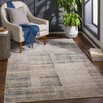 Living room scene with cream chair and Leechburg Luxe Fringe Rug in cream, denim, and beige. Roomscene-Rectangle