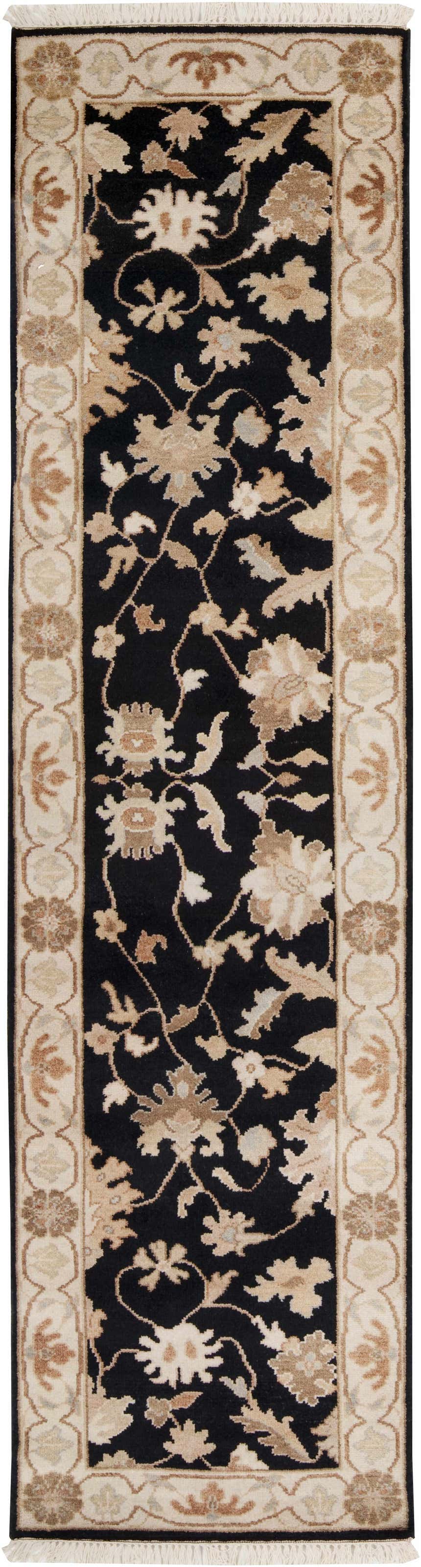 Close-up of Lenapah Area Rug. Beige floral pattern on a black background with a decorative bone border and fringe. Design-Runner-2610