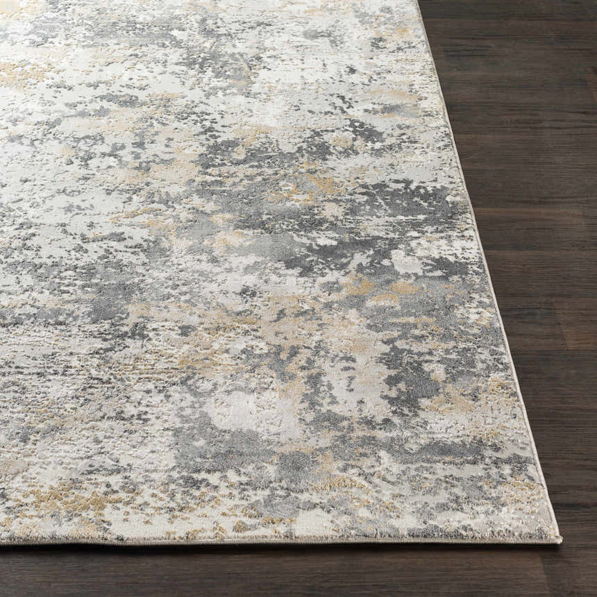 Close-up of Lenzburg Faux Silk Abstract Rug. Charcoal, gray, light gray, and mustard abstract pattern on dark wood floor. Front