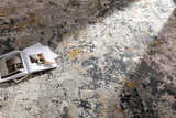 Close-up of the Lenzburg Faux Silk Abstract Rug, showcasing its charcoal, gray, and mustard abstract design and soft texture. Styleshot