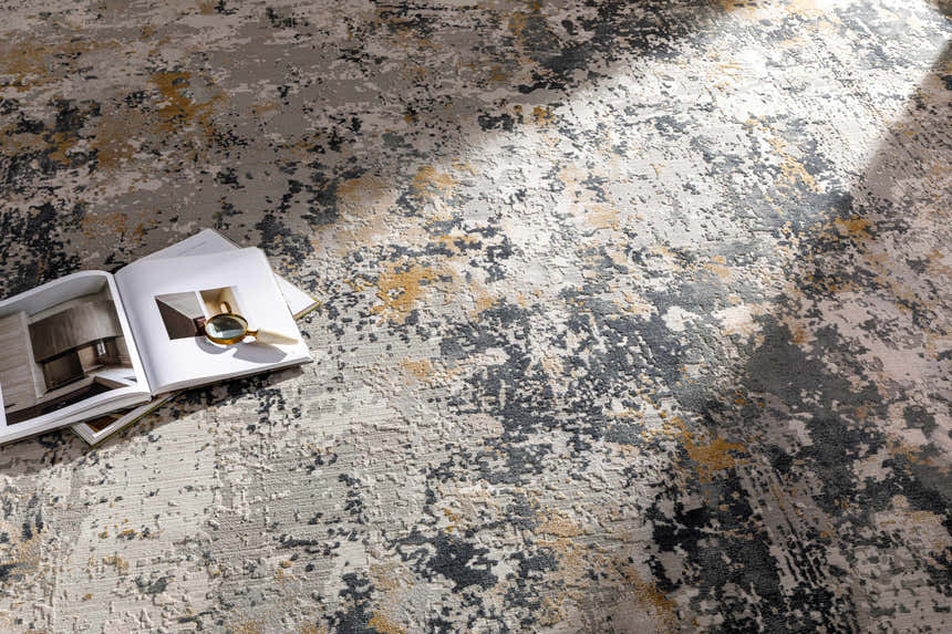 Close-up of the Lenzburg Faux Silk Abstract Rug, showcasing its charcoal, gray, and mustard abstract design and soft texture. Styleshot