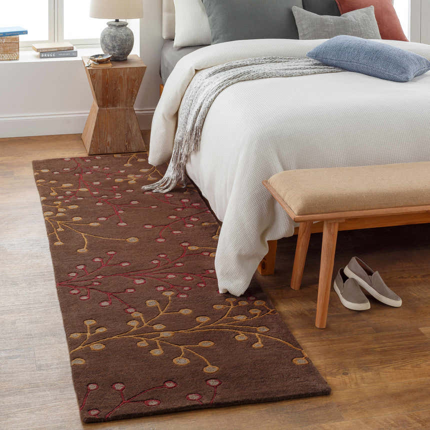 Bedroom scene with a brown Elsu Area Rug. Floral rug in a neutral bedroom with wood floors and a white bed. Roomscene-Runner