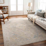 Living room scene with a Leya Thick Luxe Area Rug in charcoal, tan, and blue. Sofa, chair, and wood floors create a cozy feel. Roomscene-Rectangle