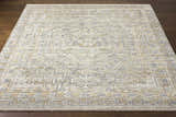 Close-up of the Ligao Area Rug, a hand-knotted rug in charcoal, light gray, tan, and wheat with a traditional geometric pattern. Front