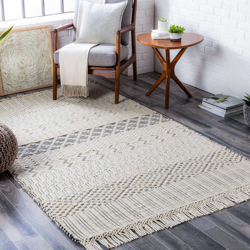 Living room scene with cream Limoges Area Carpet, gray chair, wood table, and neutral decor. Contemporary farmhouse style. Roomscene-Rectangle