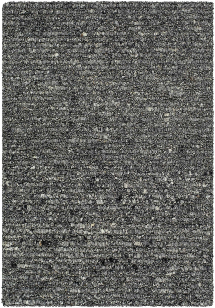 Close-up of the hand-tufted Winta Black Wool Area Rug. Gray, medium gray, and onyx tones create a textured, farmhouse style. Design-Rectangle-23