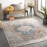 Bohemian-style room with Lake Area Rug in blue, coral, and tan. Bench with pillows, side table, and potted plant create a cozy vibe. Roomscene-Rectangle