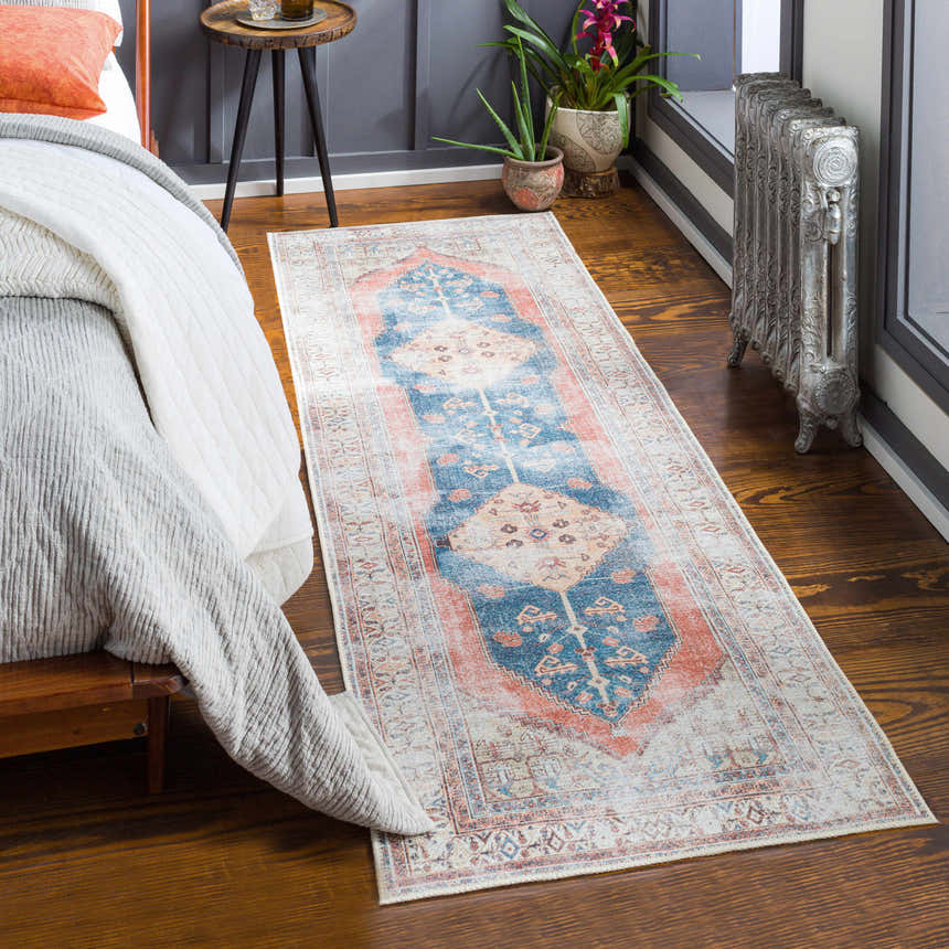 Bedroom scene with a Lake Area Rug runner in blue, coral, and tan. Bohemian style rug on hardwood floors. Roomscene-Runner