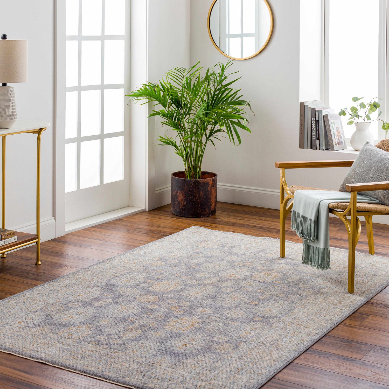 Living room with Coby Brown Avant Garde rug, wood floors, gold accents, and natural light. Farmhouse style. Roomscene-Rectangle