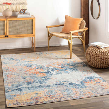 Coastal living room with blue, orange, and cream Landen Area Rug, woven chair, and wood cabinet. Roomscene-Rectangle
