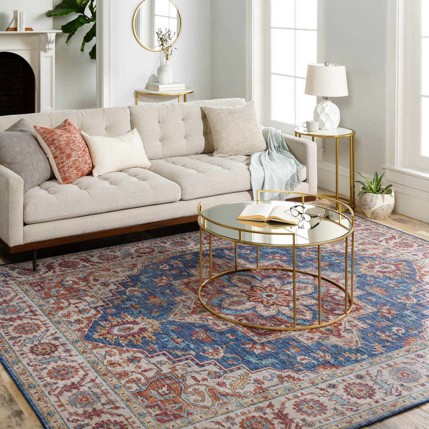 Living room scene with a Kapaa Blue Medallion Rug, beige sofa, gold coffee table, and natural light. Farmhouse style. Roomscene-Rectangle