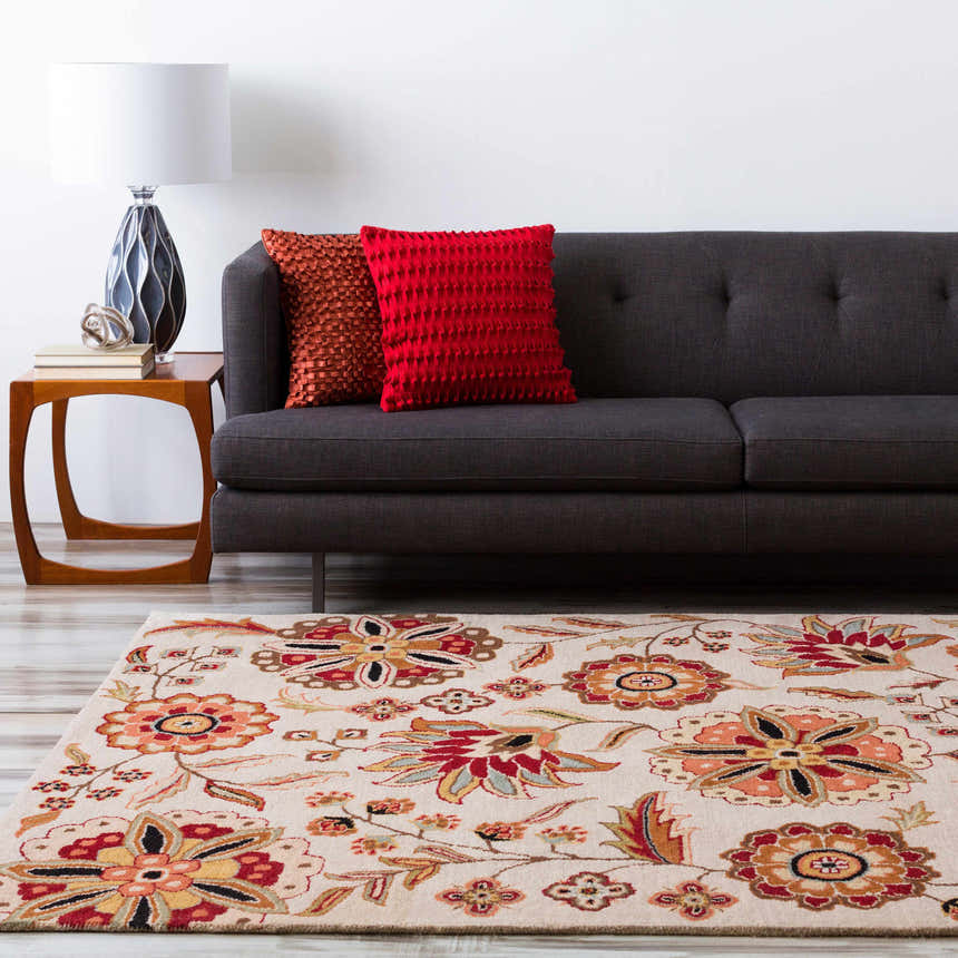 Living room scene with a Longford Beige Floral rug, gray sofa, wood side table, and bright red pillows. Roomscene-Rectangle