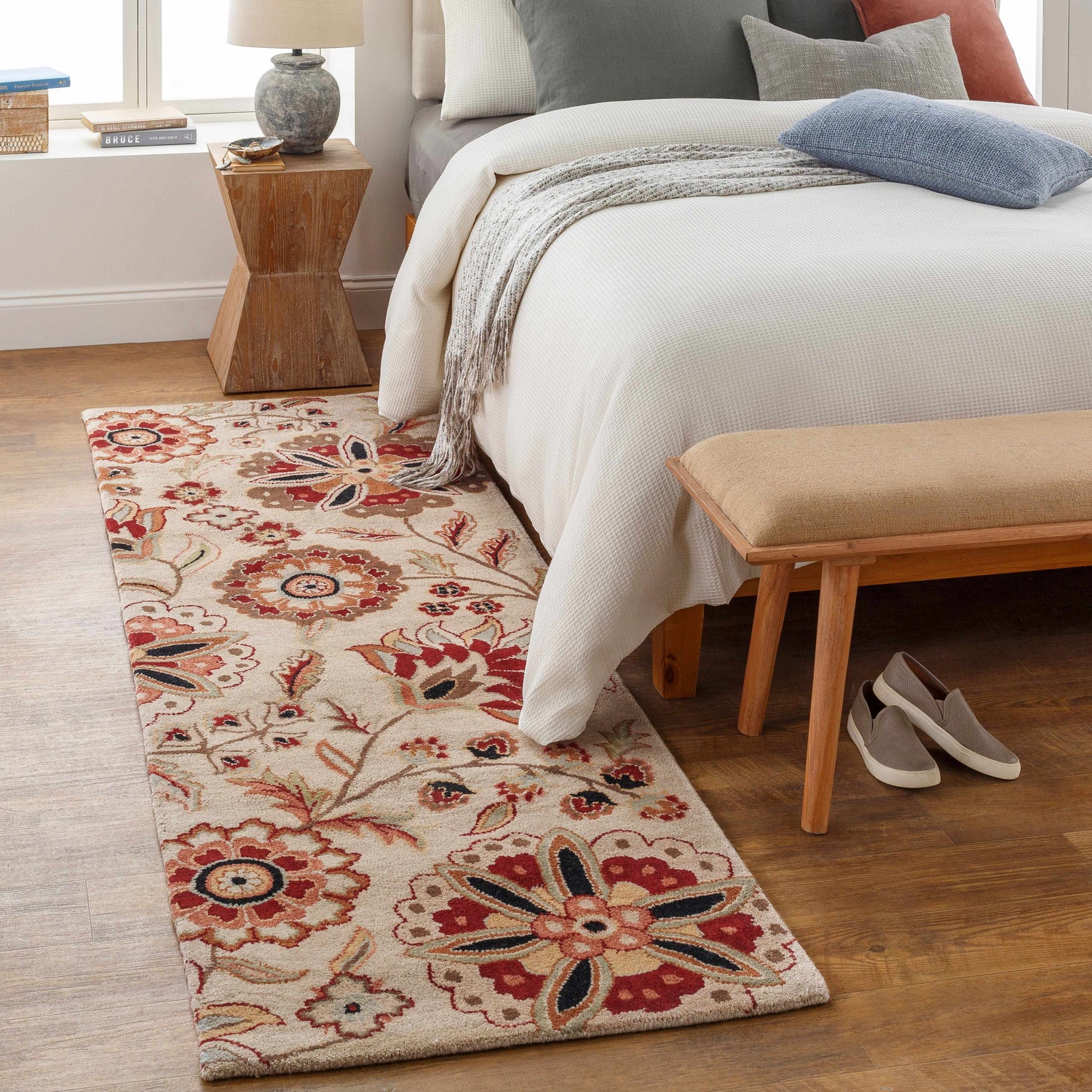 Bedroom scene with Longford Beige Floral rug, wood floors, white bedding, and neutral accents. Roomscene-Runner