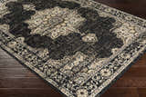 Close-up of the Lostwithiel Black Medallion Rug. Features a traditional, vintage design in black, beige, and brown tones. Corner