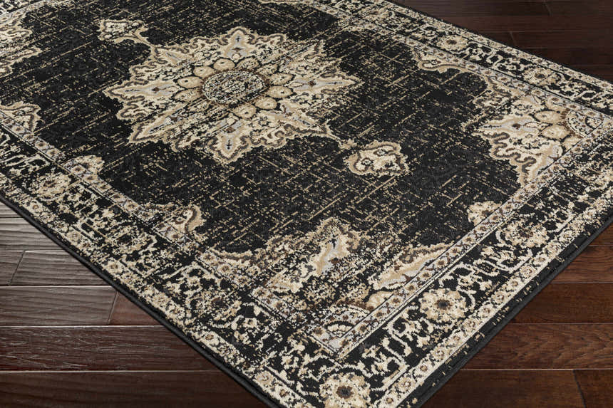 Close-up of the Lostwithiel Black Medallion Rug. Features a traditional, vintage design in black, beige, and brown tones. Corner