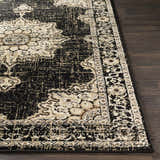 Close-up of the Lostwithiel Black Medallion Rug. Features a traditional, vintage design with black, beige, and brown colors. Front