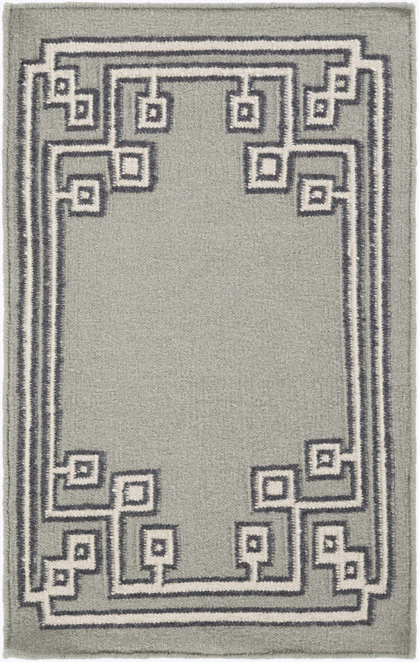 Close-up of the hand woven Lott Area Rug. Gray wool rug with ink blue and light gray geometric border pattern. Design-Rectangle
