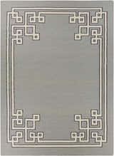 Close-up of the hand-woven Lott Area Rug. Gray wool rug with a contemporary geometric border in light gray and ink blue. Design-Rectangle