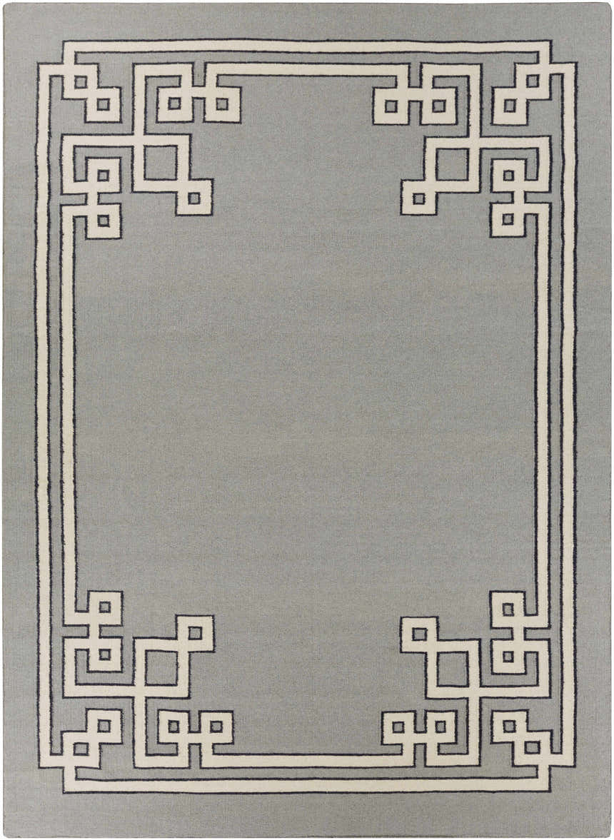 Close-up of the hand-woven Lott Area Rug. Gray wool rug with a contemporary geometric border in light gray and ink blue. Design-Rectangle