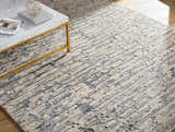 Close-up of the Lowdham Premium Rug. Contemporary design in cream, light beige, medium gray, and taupe. Hand-knotted viscose texture. Styleshot