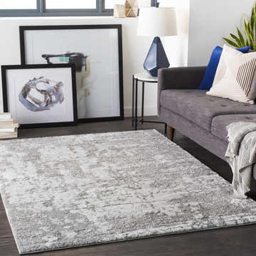 Living room scene with gray sofa and Elsa Area Rug in black, gray, and ivory. Contemporary style. Roomscene-Rectangle