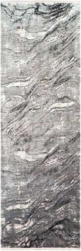 Close-up of the Littleport Luxury Fringed Faux Silk Rug. Abstract design in black, charcoal, gray, and light gray tones. Design-Runner