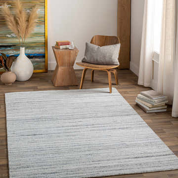 Styled room featuring the Lubigan Area Rug in charcoal and light gray with a contemporary design. Roomscene-Rectangle