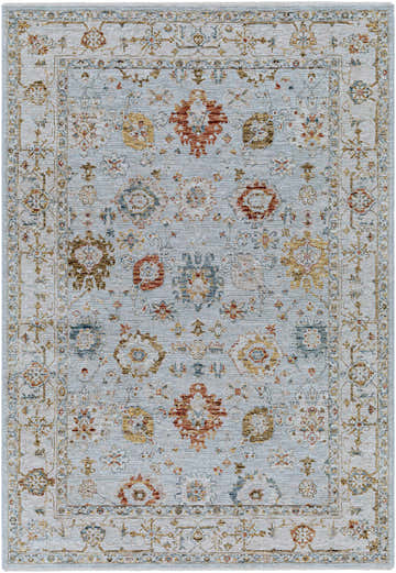 Close-up of the Luklukan Oushak Style Floral Rug. Features brick red, cream, denim, and mustard floral pattern. Design-Rectangle-575