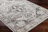 Close-up of the Liverpool Dark Gray Area Rug showing its traditional charcoal, gray, rust, and off-white pattern. Corner