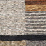 Close-up of the hand woven Lyndoch Leather Patchwork Rug. Features black, brown, and beige tones with a contemporary design. Swatch