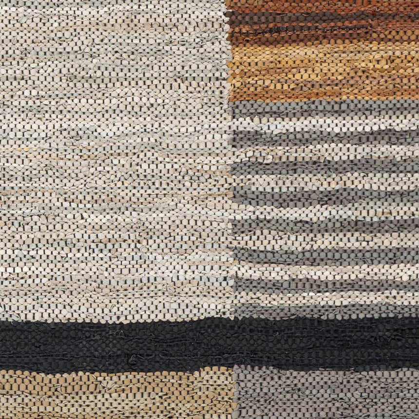 Close-up of the hand woven Lyndoch Leather Patchwork Rug. Features black, brown, and beige tones with a contemporary design. Swatch