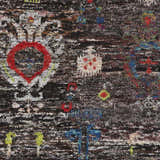 Close-up of the Macy 5x8 Black Silk Carpet, a hand-knotted rug with a bohemian design and colorful accents. Swatch