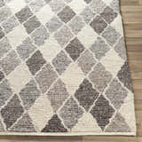 Close up of the hand woven Madden Premium Rug, featuring a gray, charcoal, and ivory diamond pattern. Front