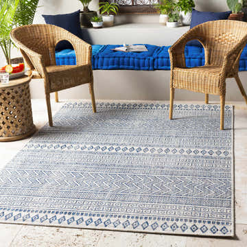 Bohemian patio with wicker chairs and Madras Light Blue Green All Over Performance Area Rug. Roomscene-Rectangle