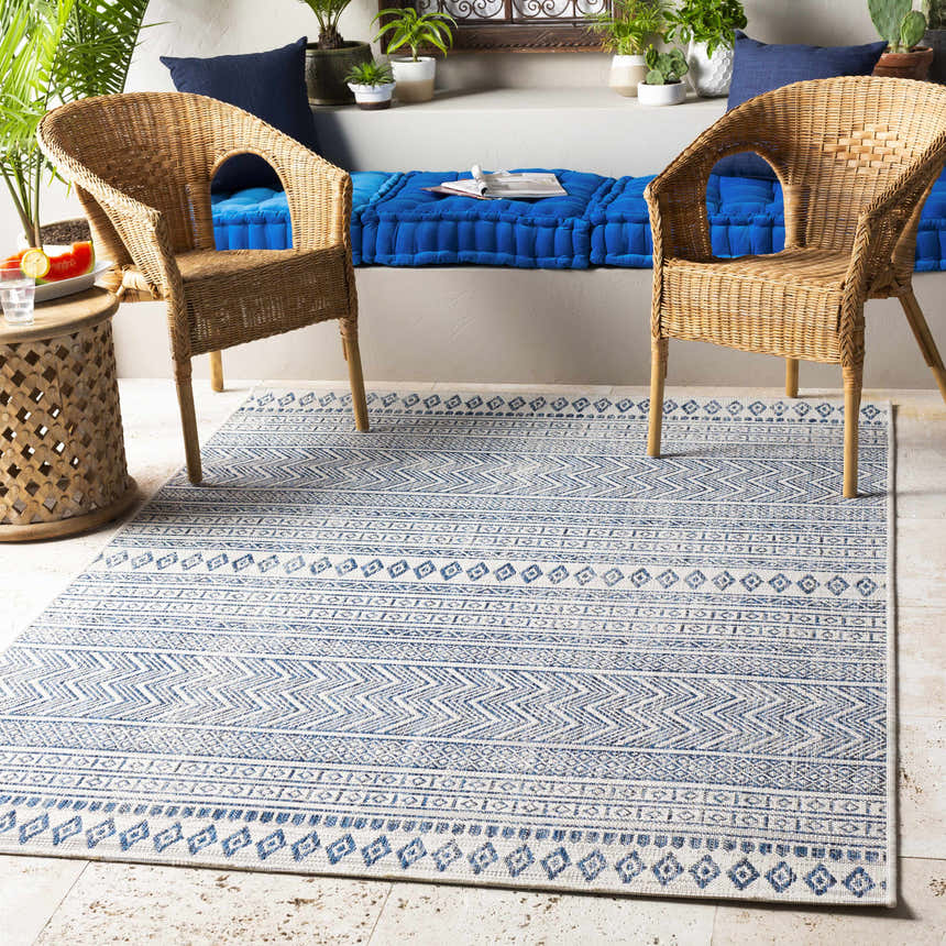 Bohemian patio with wicker chairs and Madras Light Blue Green All Over Performance Area Rug. Roomscene-Rectangle