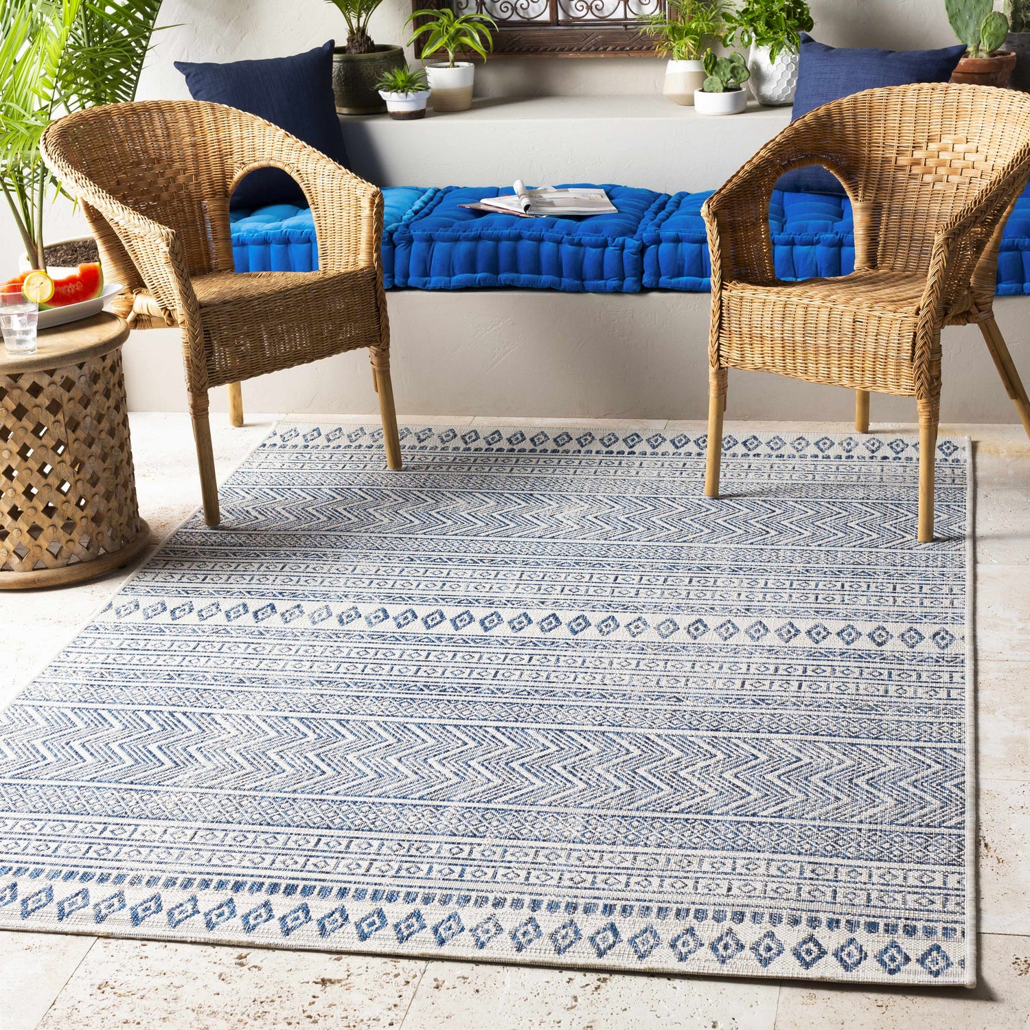 Bohemian patio with wicker chairs and Madras Light Blue Green All Over Performance Area Rug. Roomscene-Rectangle