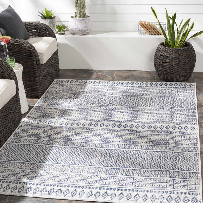 Outdoor patio scene with wicker chairs and Madras Light Blue Green All Over Performance Area Rug. Roomscene-Rectangle