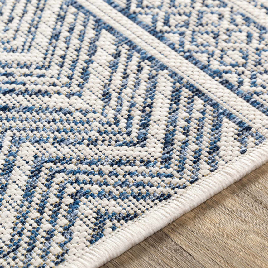 Close-up of the Madras Light Blue Green All Over Performance Area Rug showing its woven texture and geometric pattern. Texture