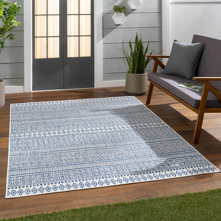 Outdoor patio scene with a Madras Light Blue Green All Over Performance Area Rug. Roomscene-Rectangle