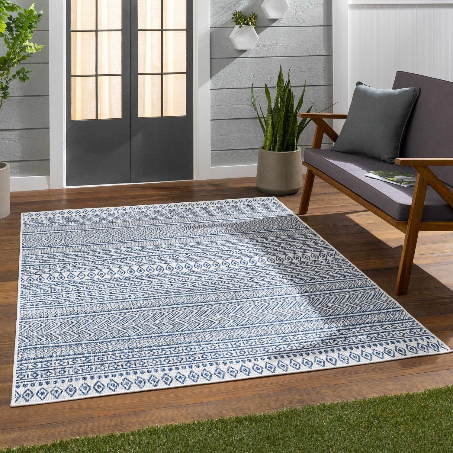 Outdoor patio scene with a Madras Light Blue Green All Over Performance Area Rug. Roomscene-Rectangle