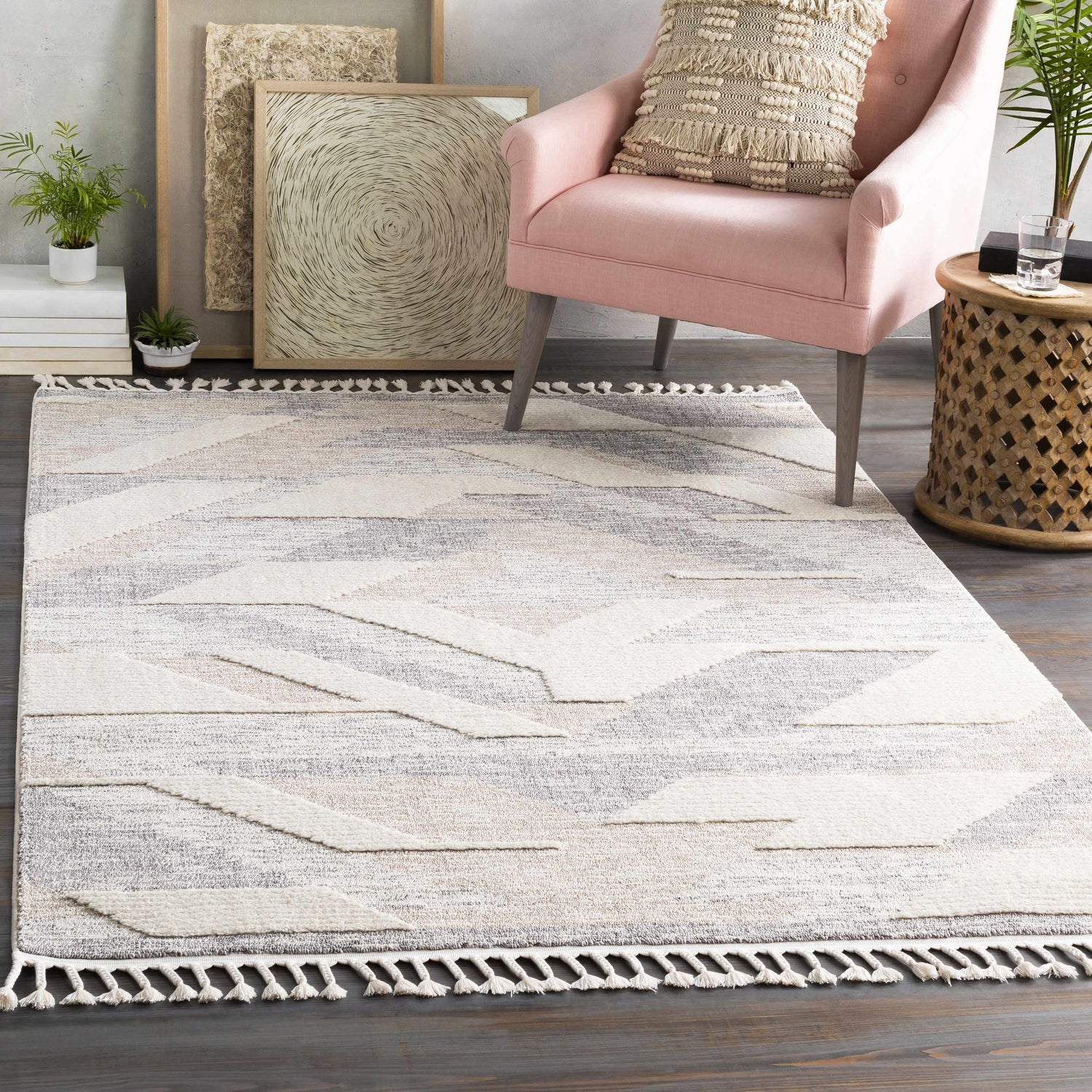 Styled room featuring Magazine Geometric High/Low Pile Rug with Tassels in gray and tan. Pink chair and wood accents. Roomscene-Rectangle