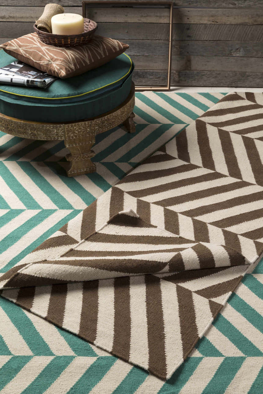 Styled scene with the Magdalena Area Carpet. Emerald and ivory striped rug with brown geometric pattern. Styleshot