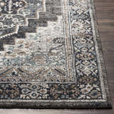 Close-up of the Manaring Luxe Thick Area Rug, a traditional design in black, brown, gray, and light blue. Front