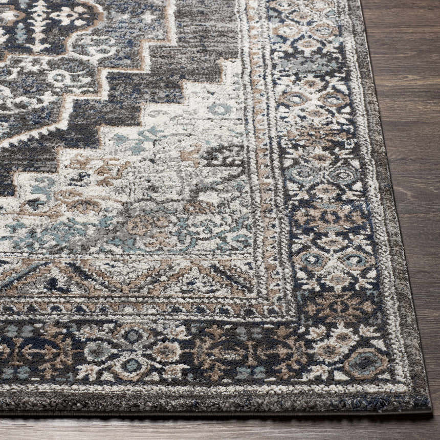 Close-up of the Manaring Luxe Thick Area Rug, a traditional design in black, brown, gray, and light blue. Front
