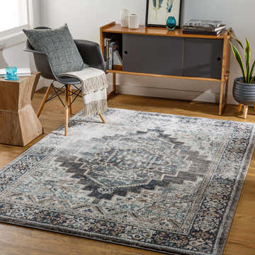 Living room scene with a Manaring Luxe Thick Area Rug in gray, blue, and brown tones. Modern furniture and wood floors. Roomscene-Rectangle