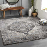 Entryway with a brown bench and the gray, blue, and cream Manaring Luxe Thick Area Rug. Roomscene-Rectangle