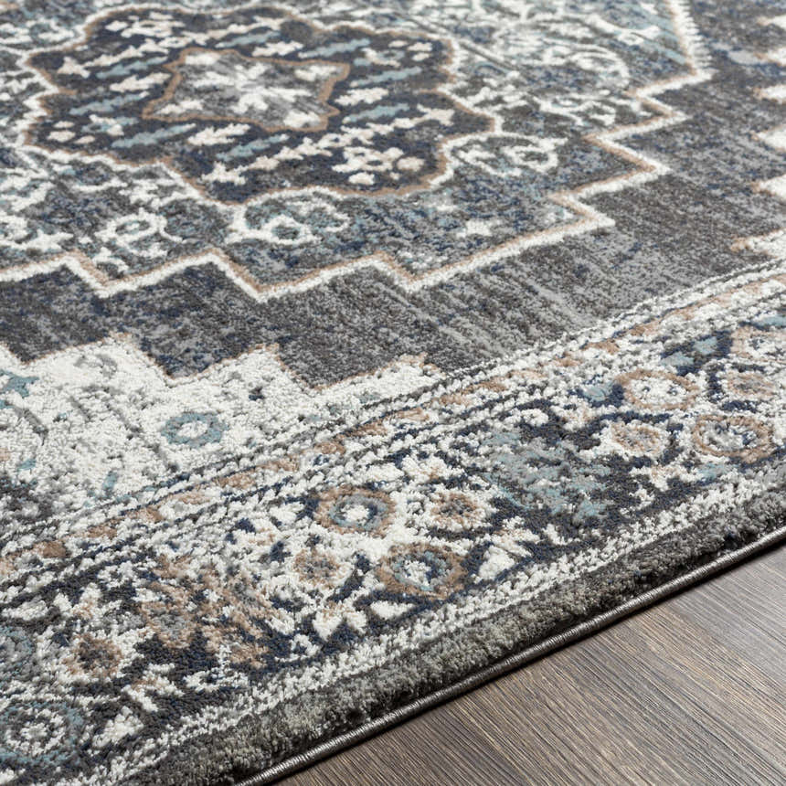 Close-up of the Manaring Luxe Thick Area Rug showing its traditional pattern, colors of gray, blue, tan, and white, and soft texture. Texture
